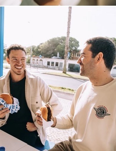 Friends enjoying burgers outside FATTY'S