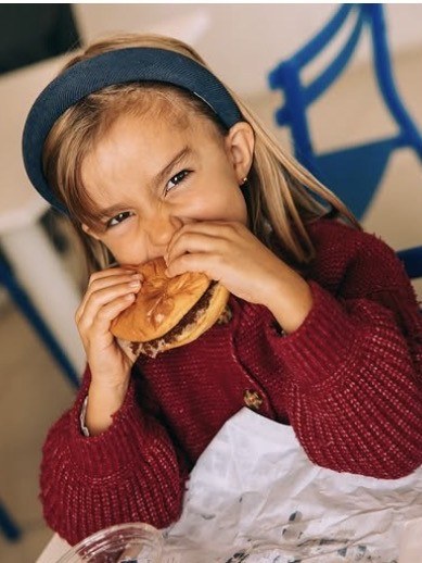 Child enjoying a FATTY'S smash burger