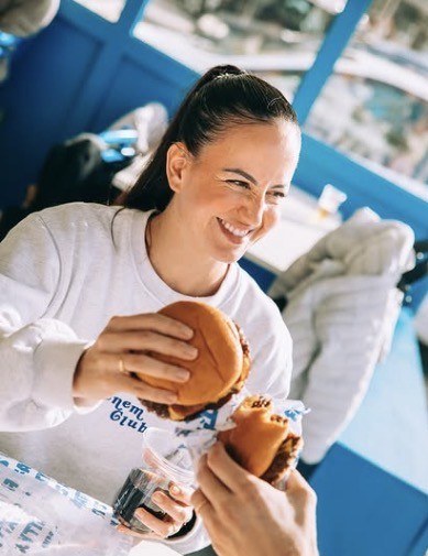 Customer smiling with a FATTY'S smash burger